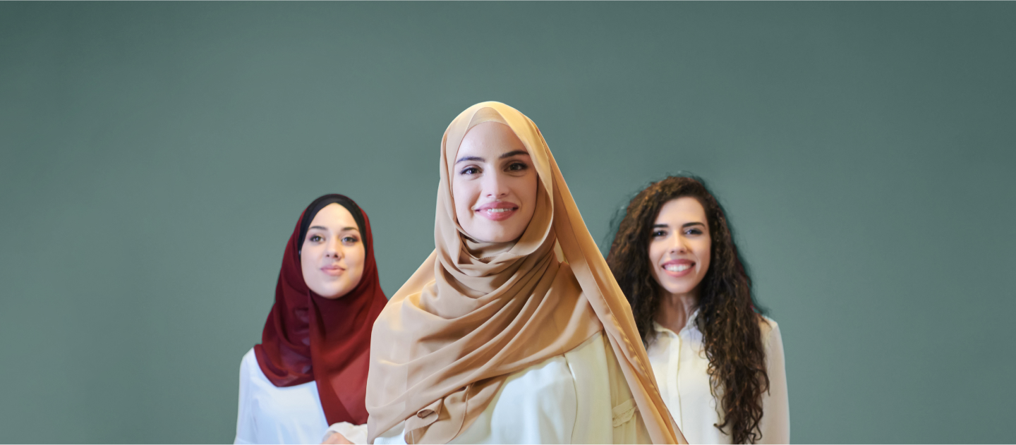 Three muslim women in hijab posing for a photo.
