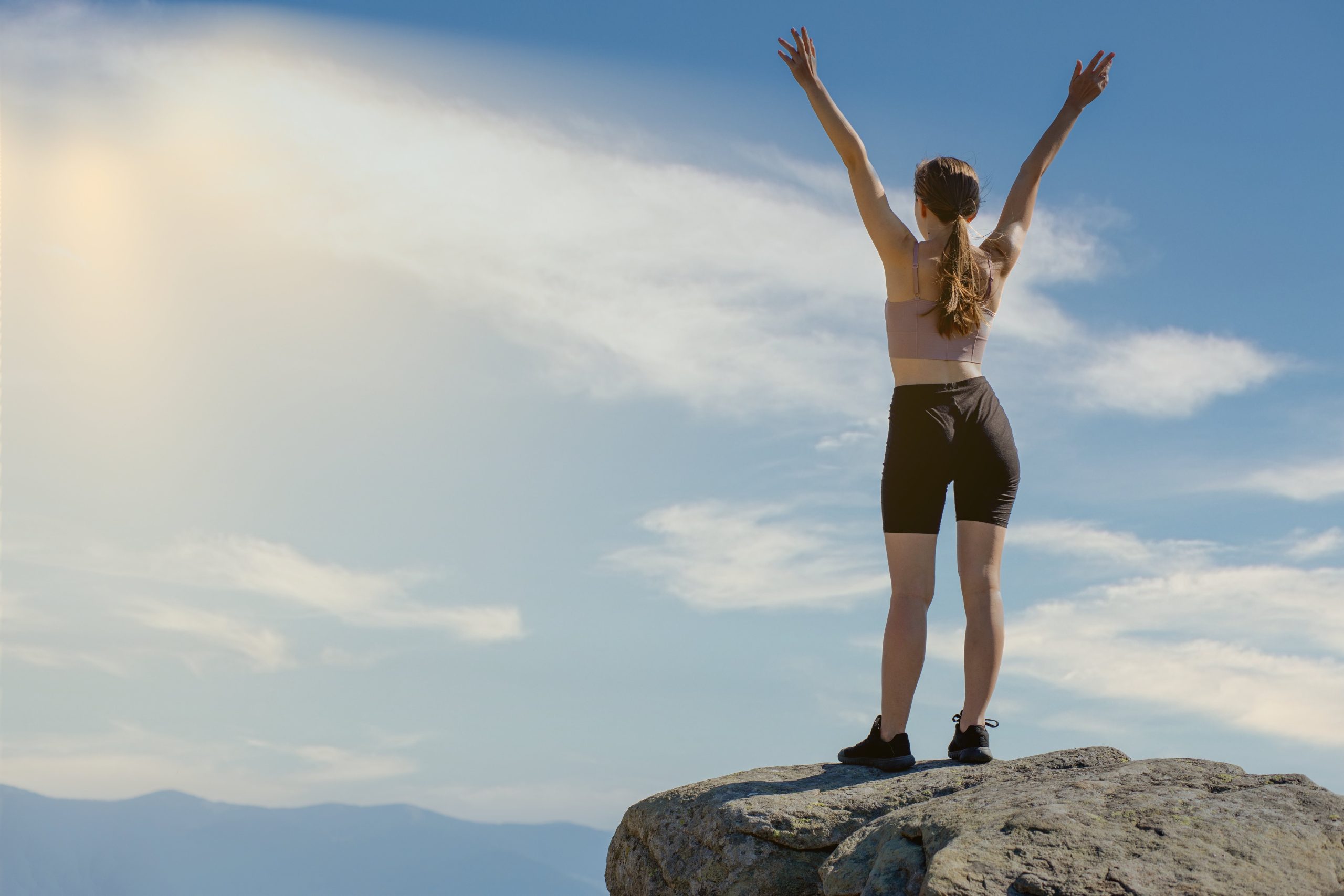 woman-standing-on-cliff-edge